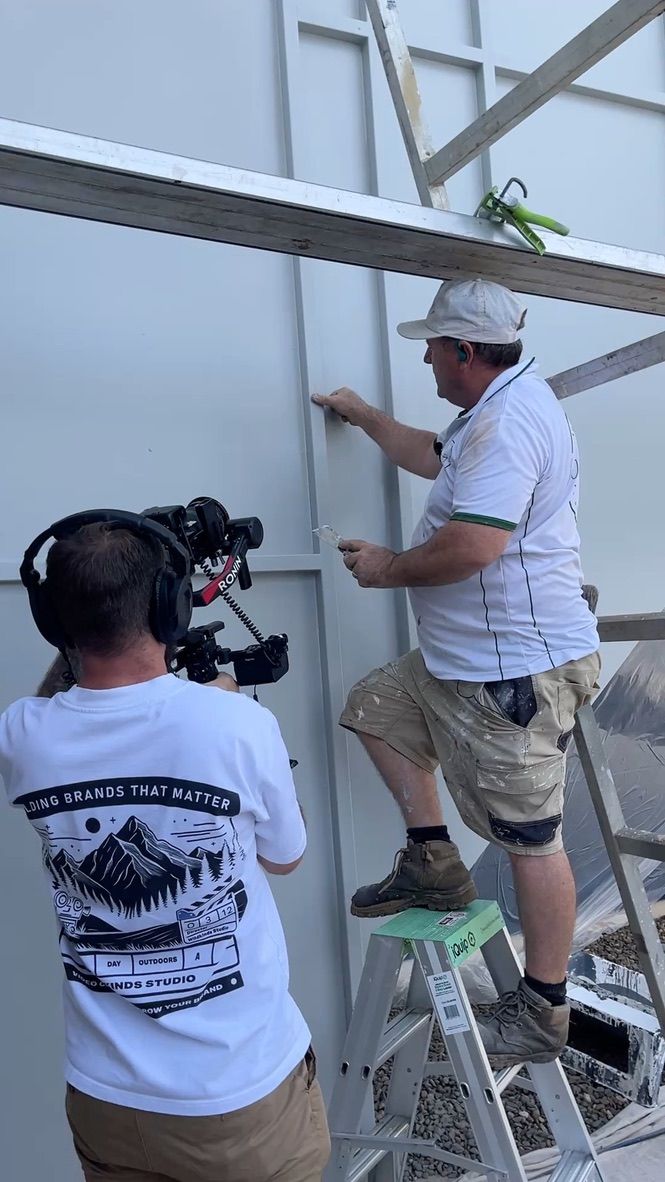 A Wildkinds videographer filming a tradie on site